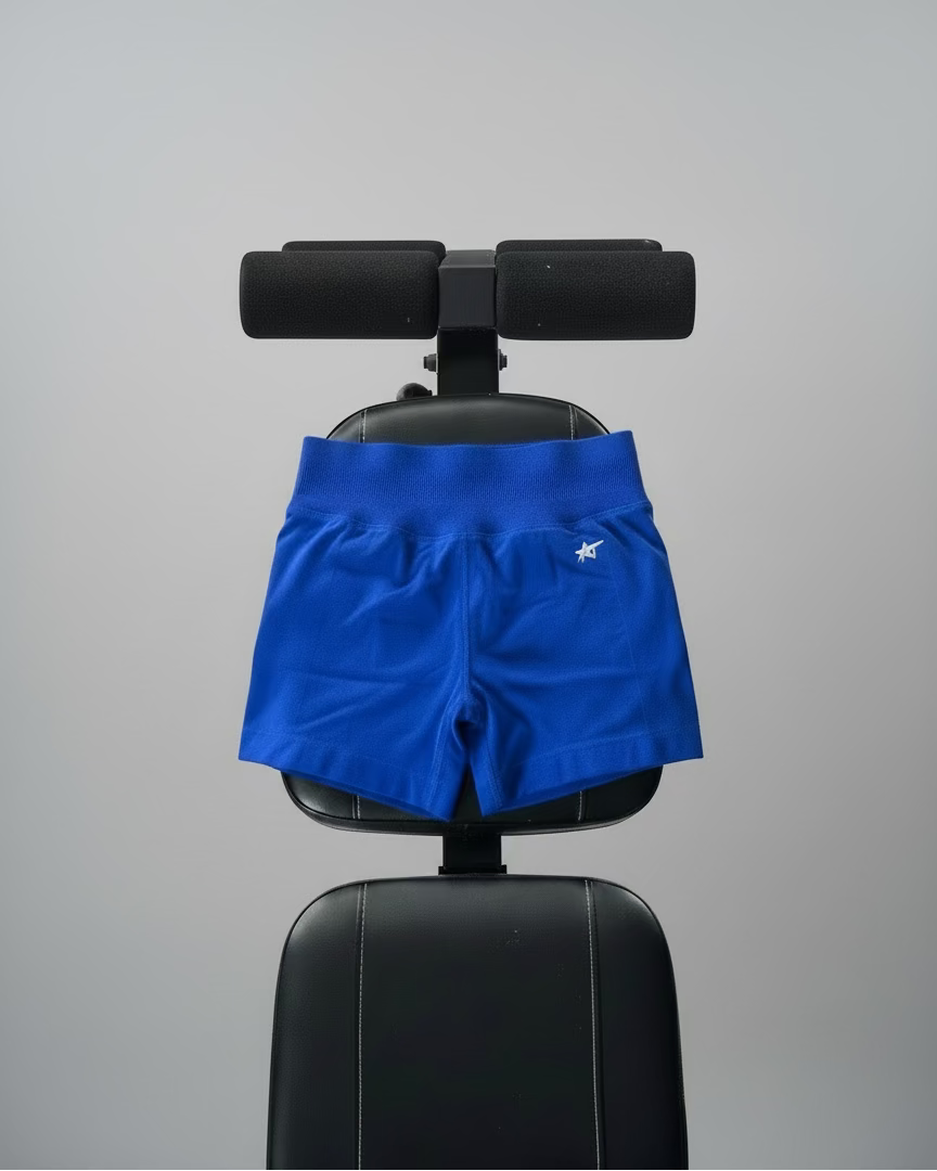 Blue shorts with a logo on a black chair against a gray background